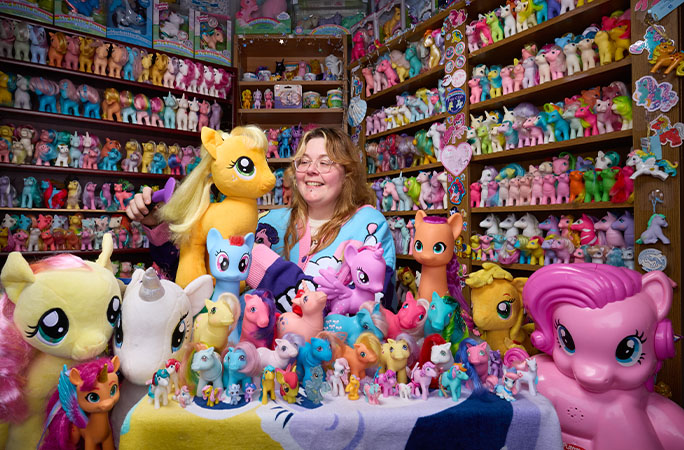 Miranda surrounded by her My Little Pony collection