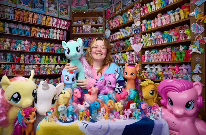 Miranda surrounded by her My Little Pony collection