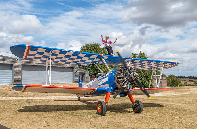 Betty sitting on top of a plane