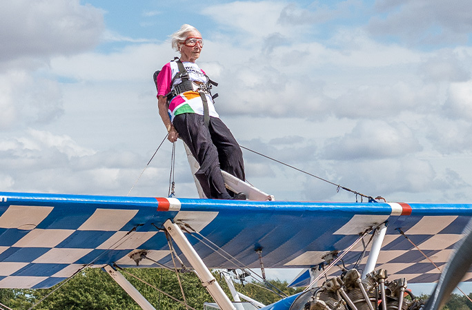 Betty sitting on top of the plane