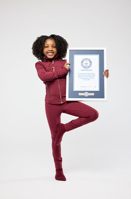 phoenix doing yoga pose with certificate