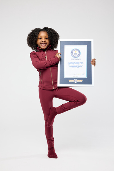 Phoenix stood with her certificate in a yoga pose