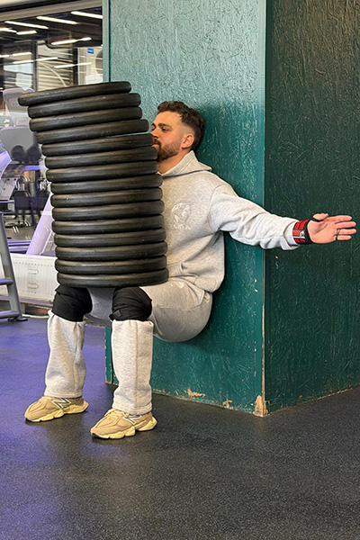 Adhurim holding the weights in his lap