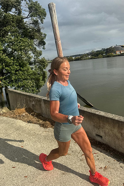 Shannon running in front of a lake