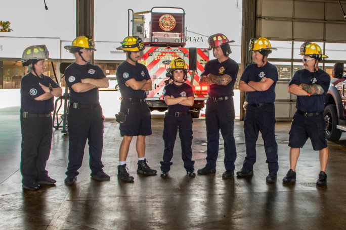 The crew standing next to Autumn with their arms crossed