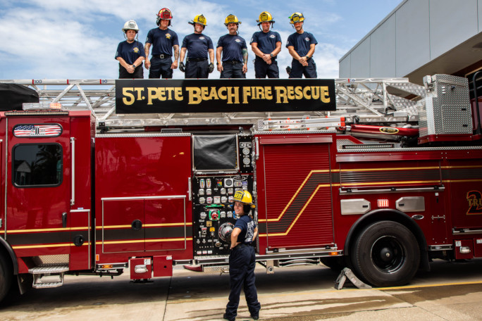 The crew on the firetruck staring down at Autumn