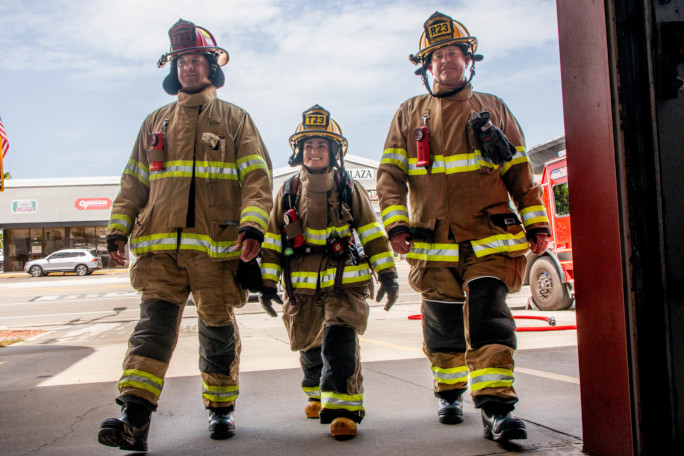 Autumn and two of her crewmates walking into the firehouse