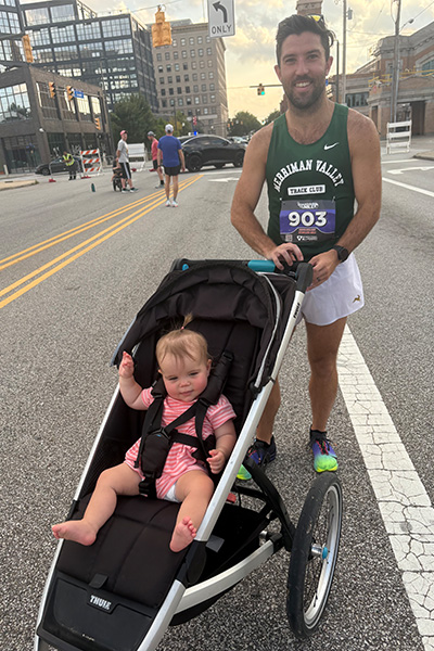 Stephen stood with his daughter Blake in a stroller at the Guardian Mile race