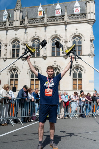 Jonathan holding his stilts in his hands at the finish line