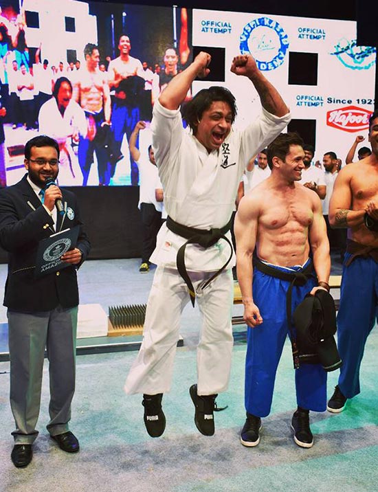 Martial arts pros form 8layer bed of nails sandwich in recordbreaking