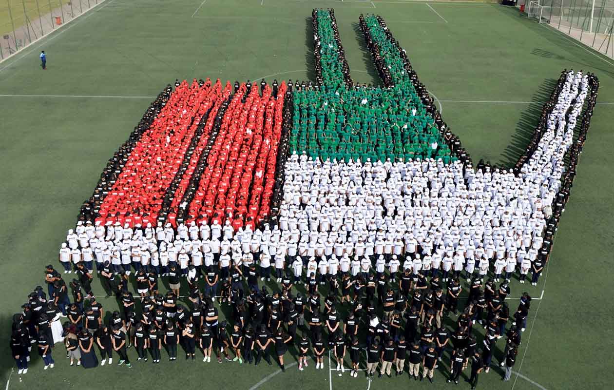 Largest human transforming image of three finger salute