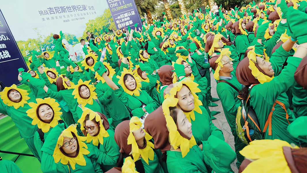 In pictures: Hundreds of families dressed as sunflowers set record in China  | Guinness World Records