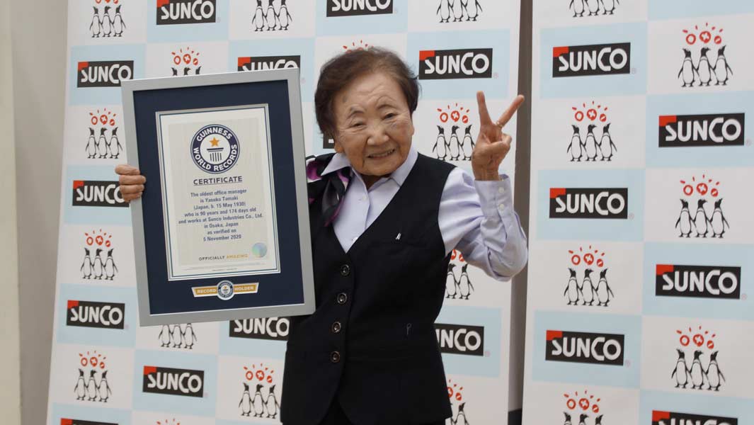 Oldest office manager smiles with her official certificate