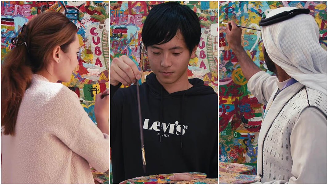 People passing and using a paint brush in an online video chain attempt
