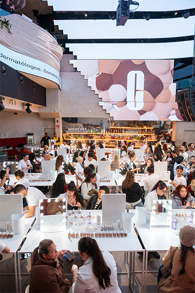 participants sit at their makeup stations to get their foundation matched