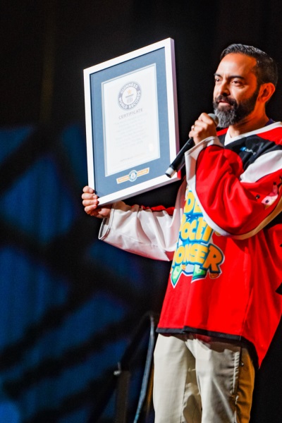 A man holds a Guinness World Records certificate