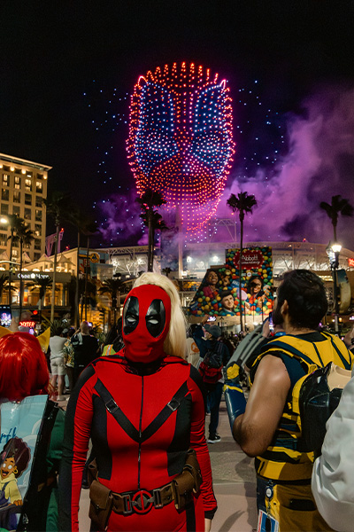 Deadpool made of drones with fan dressed as character stood in front