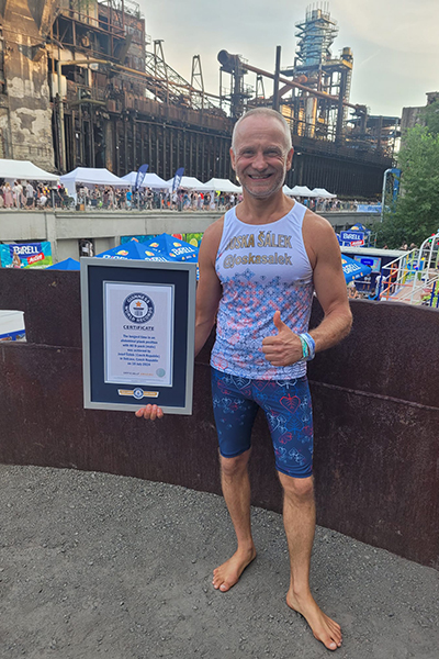 josef salek smiles while holding his Guinness World Records certificate