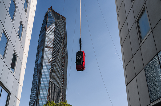 red-nissan-car-hangs-upside-down-in-the-sky