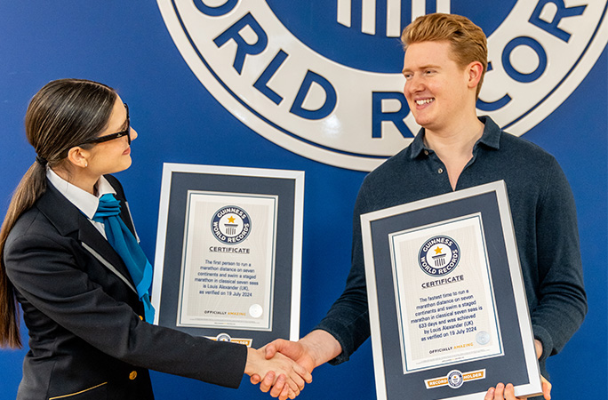 louis alexander is presented with his two guinness world records certificates