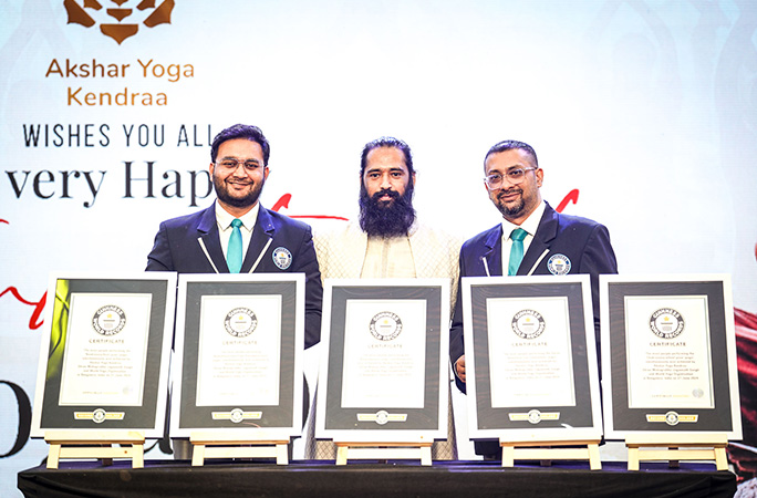 master anshu stands with two guinness world records adjudicators with official certificates