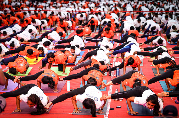 participants raise their left leg in yoga pose