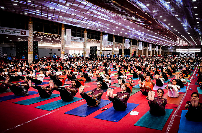 participants raise leg into the air in yoga pose