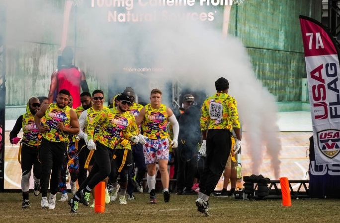 Players jump on the field during largest flag football tournament