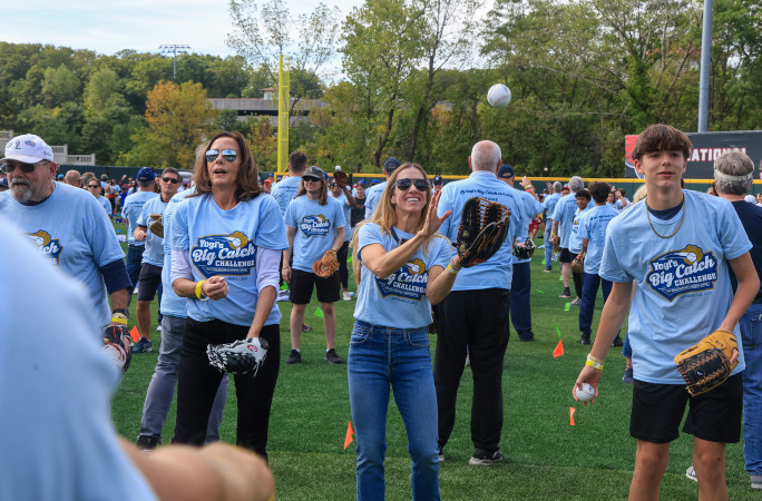 A woman catching the baseball