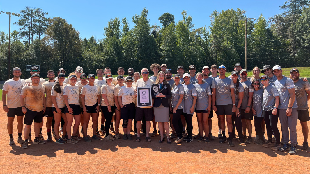 Kickball teams taking a photo with GWR certificate on the field