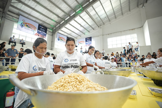 Chefs with a bowl of pili nuts