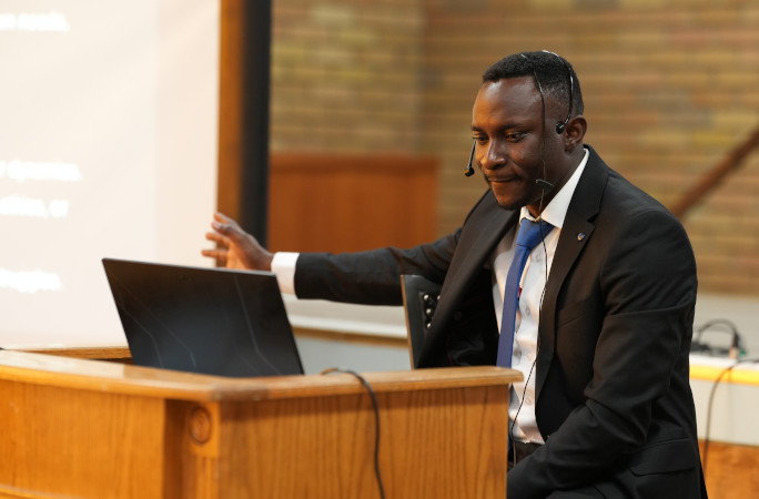 Peter pointing at his Powerpoint