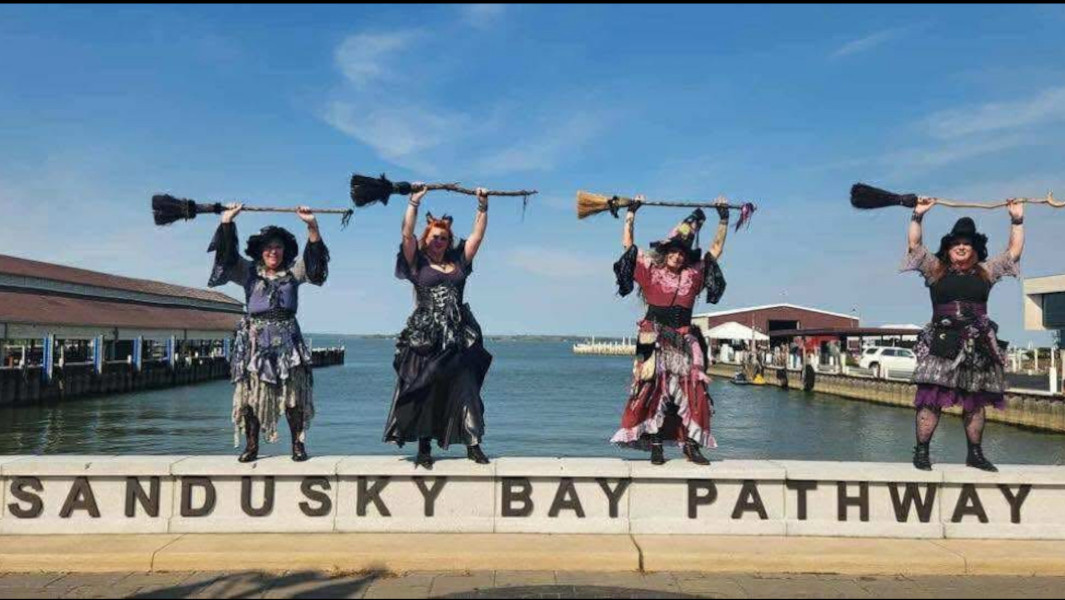 Witches displaying their broomsticks on Sandusky pier