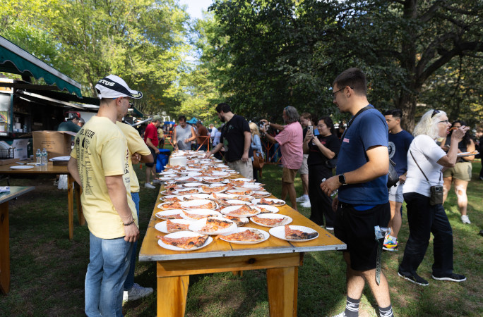 Crowd lining up for a slice