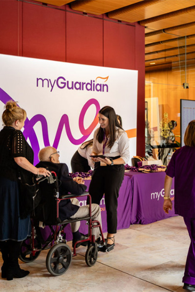 man in a wheelchair being greeted