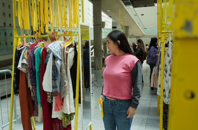Woman trying on a pink top