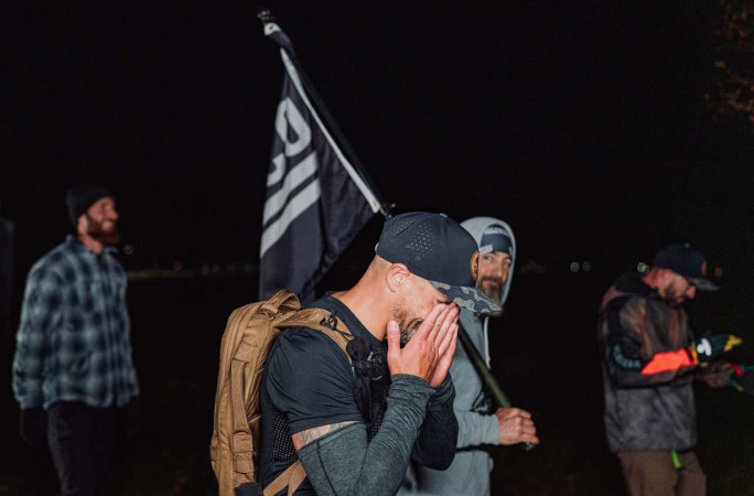 An emotional Mark walking next to the Oscar flag
