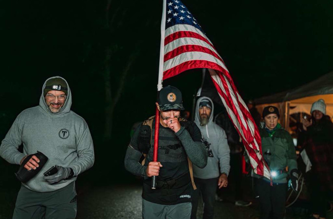 An emotional Mark next to the American flag