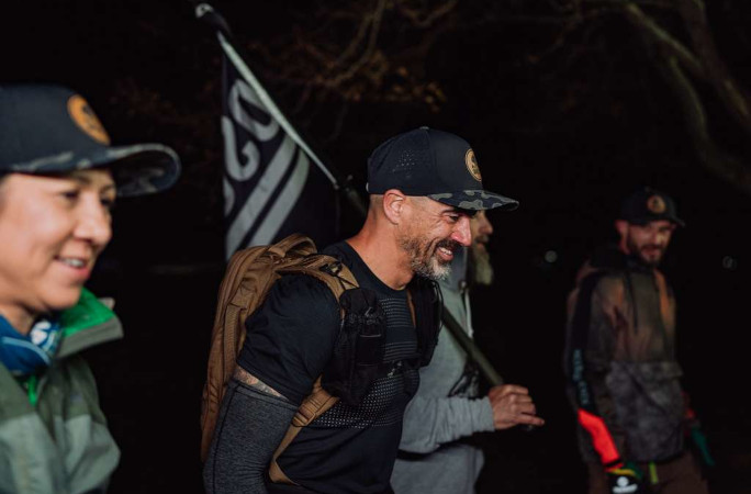 Smiling next to the Oscar Mike flag