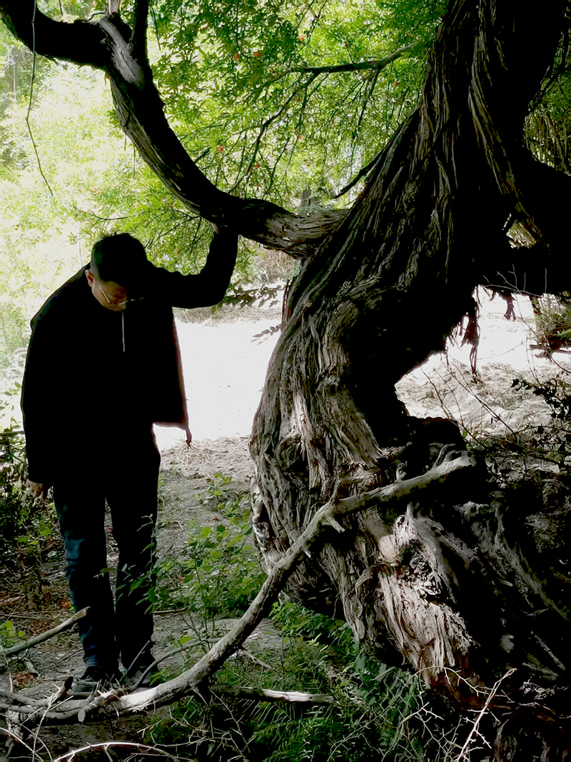 Man standing next to the vine