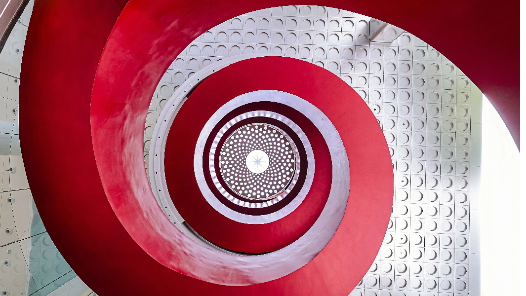 split image of spiral staircase from the side and above