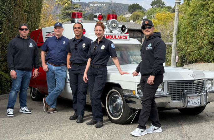 EMS team poses around the ambulance