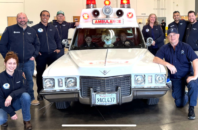 The ambulance surrounded by firefighters