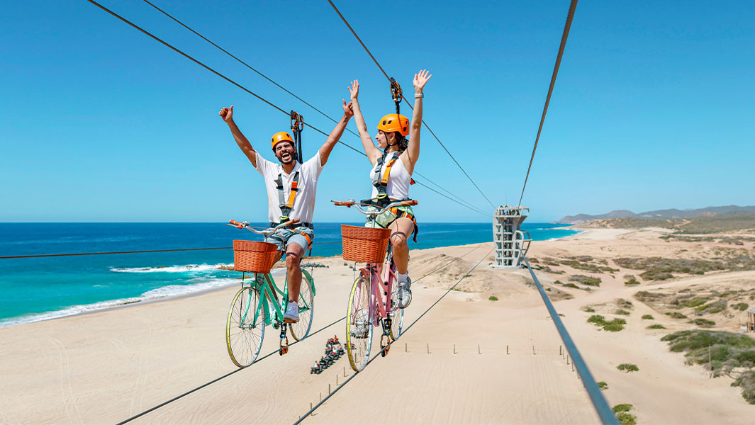 People riding on the longest bicycle zip wire