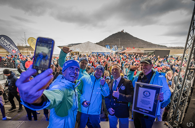 david vencl takes a selfie with participants and guinness world records adjudicator while holding the guinness world records certificates