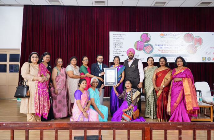 mother india crochet queens pose with their guinness world records certificates