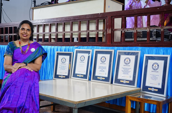 subashri sitting next to a row of guinness world records certificates
