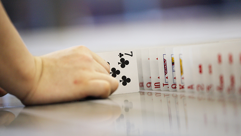staff-arranging-playing-cards-close-up