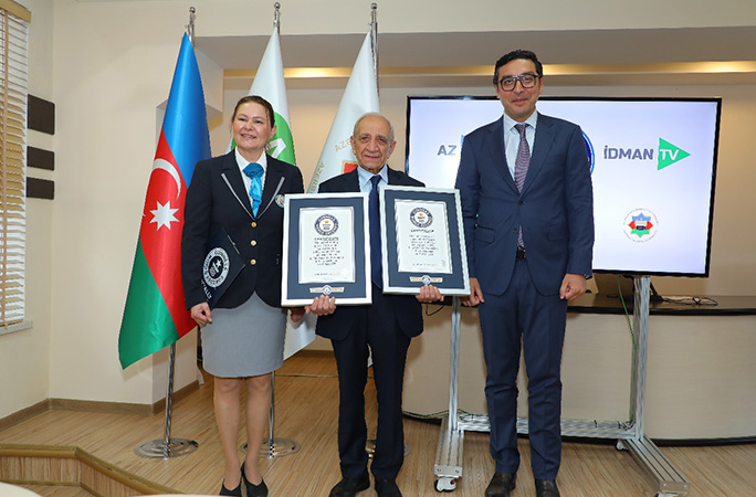 faig gasanov wearing a suit is awarded his guinness world records certificate