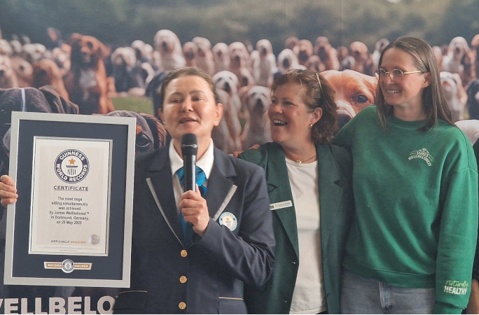 Adjudicator presenting officials with the certificate